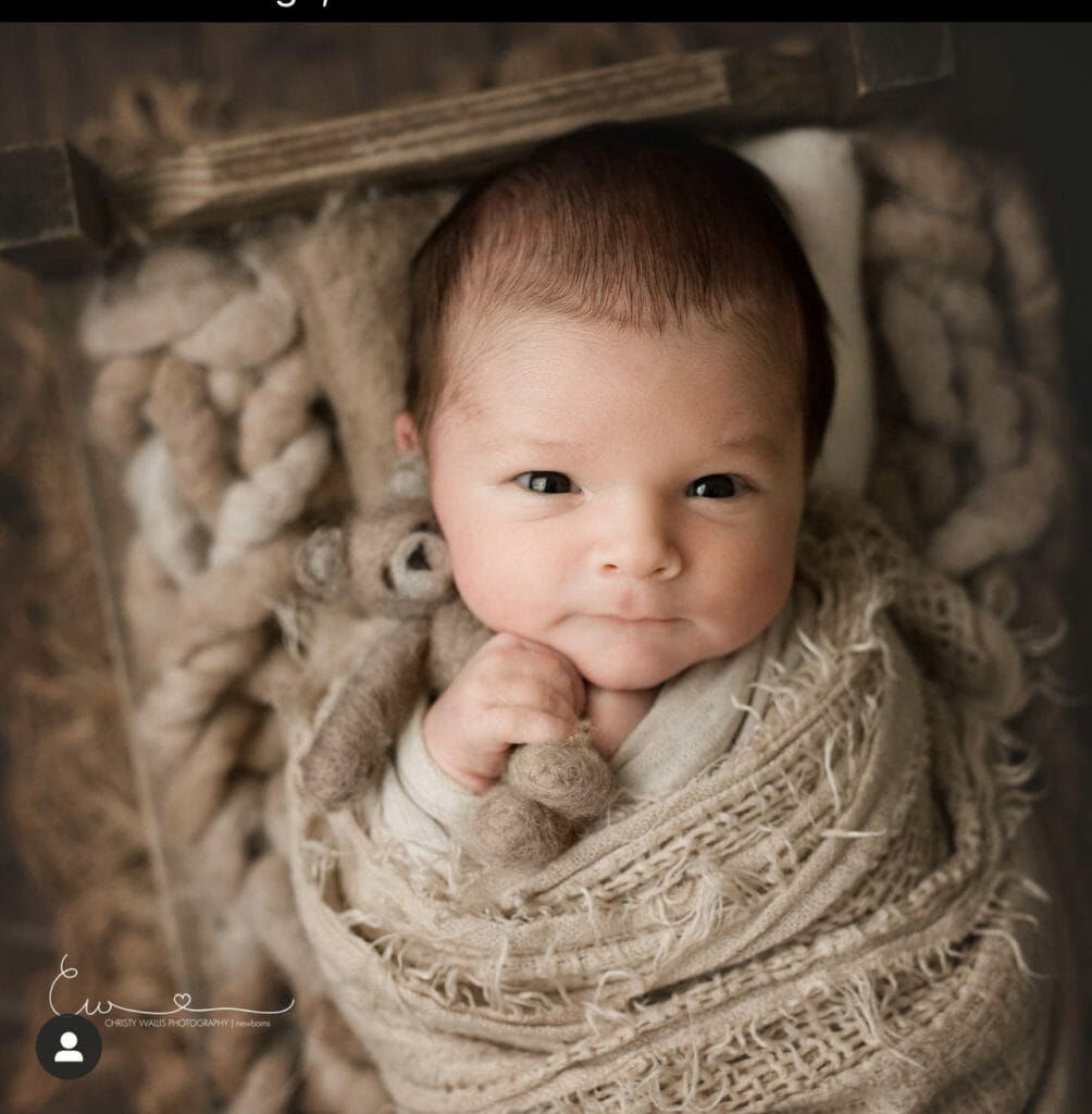 San Diego newborn baby boy wrapped in cozy organic bed
