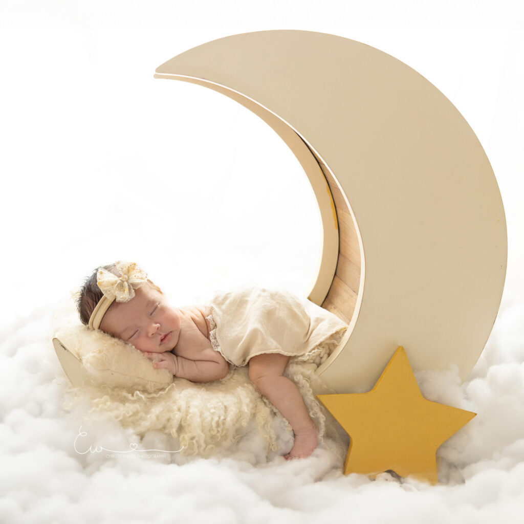 Newborn with moon prop