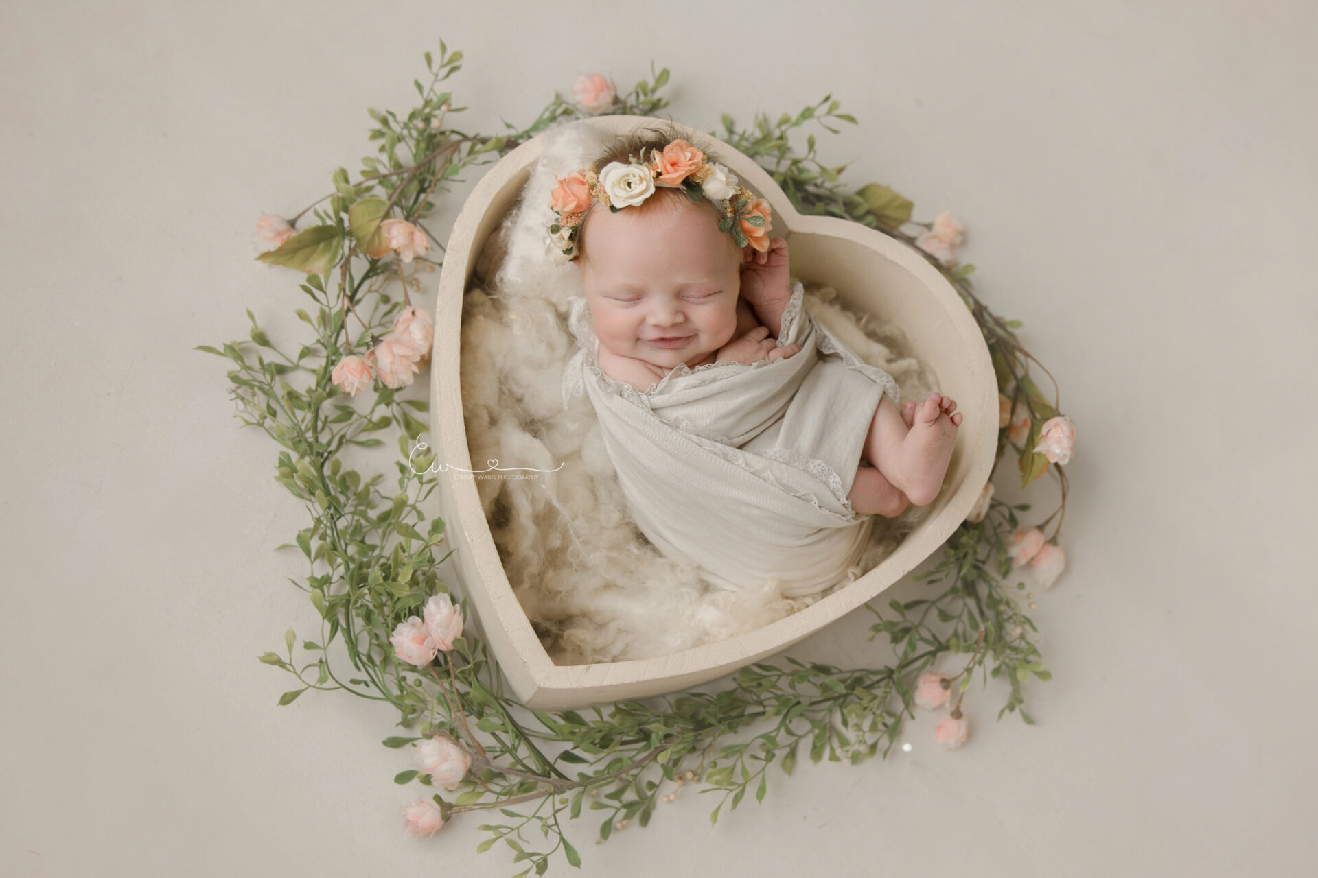 San Diego Newborn Photographer Beautiful Newborn in soft swaddle with greenery and heart box