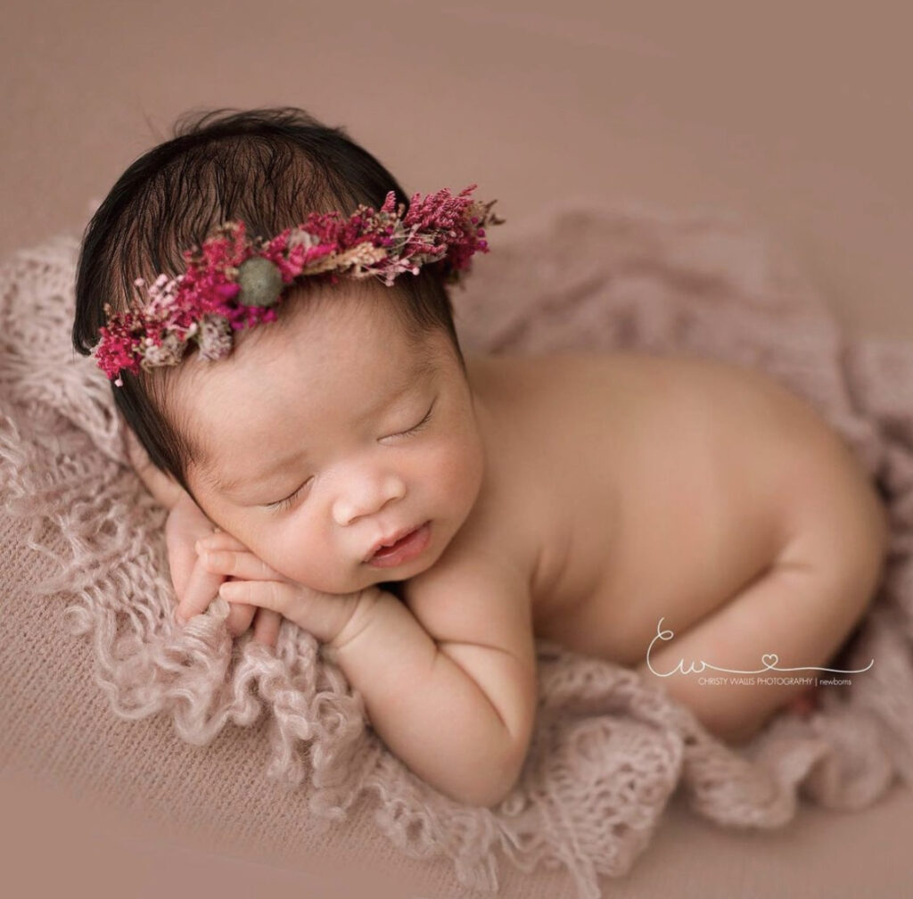 Wrapped newborn on textured blanket